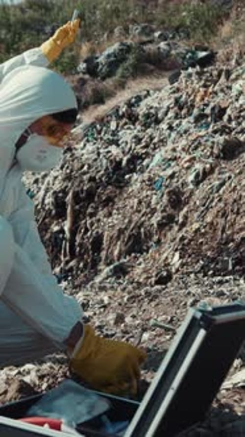 Scientist Takes Garbage Sample in a Hazmat Suit