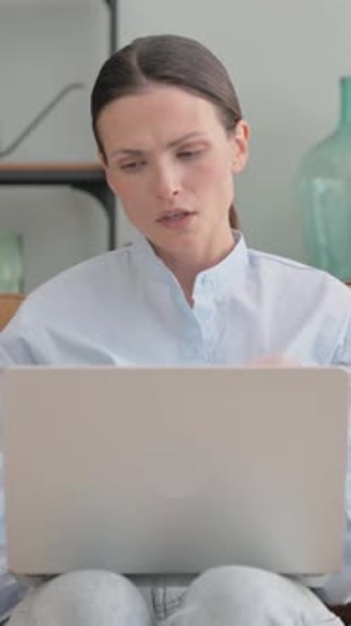 Woman Working on Laptop at Home Massaging Neck