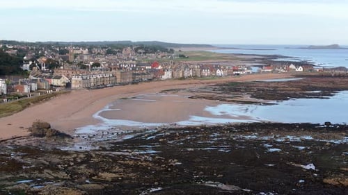 Aerial footage of North Berwick, Scotland in golden morning sunlight. stunning views of the town’s h