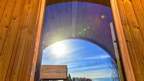 Passage of daytime sunlight facade of wood cabin cottage