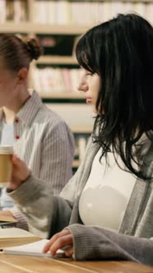 Vertical Video Portrait of Classmates in Study Group Sitting at Library Table with Textbooks