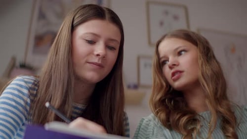 Adolescente prenant des notes et discutant avec un ami