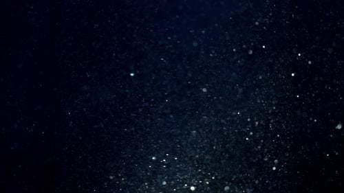 Floating Underwater Particles in Blue Liquid With Light Rays