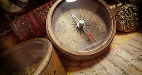 Vintage style travel and adventure. Vintage old compass and other vintage items on the table.