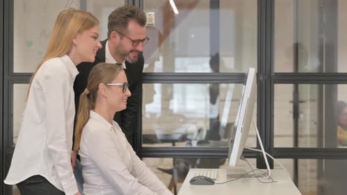 Team Celebrating Success in Modern Office