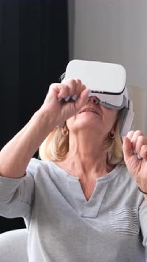 Senior Woman Enjoys Virtual Reality Headset in Living Room