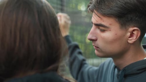 Young Couple Negotiates Calmly Outdoors Urban Park Scene with Tense Couple Talking Casual Urban