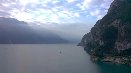 Dolly out aerial shot revealing the magnitude of Lake Garda with a large boat giving sense of space