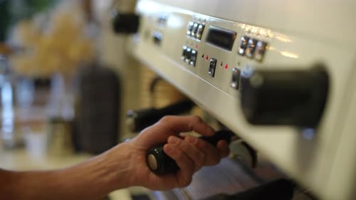Side Angle View Closeup Male Caucasian Hand Attaching Portafilter to Coffee Maker in Slow Motion