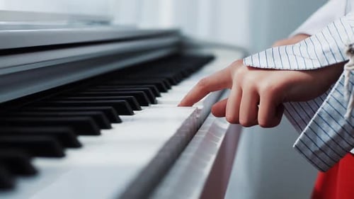 Child Playing White Piano Close Up Indoors