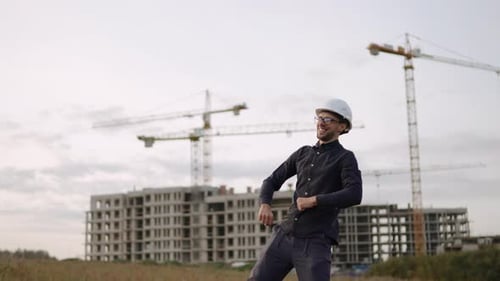 Construction Worker Dances Near Construction Site
