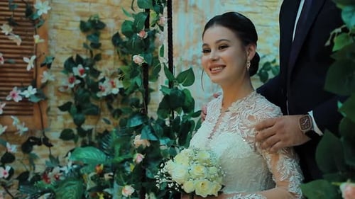 Elegant Bride Holding Bouquet Smiles Beautifully