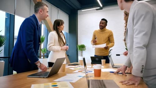 Black male team leader at business meeting in an office, discussing business affairs with other work