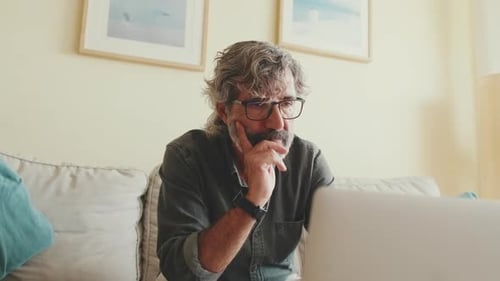 Mature Man Working on Laptop at Home