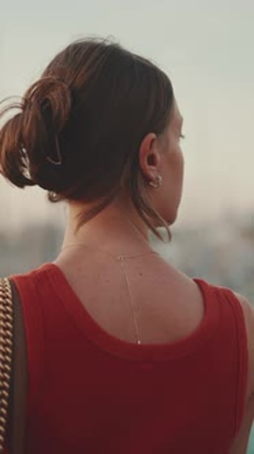 Close-up, girl stand on the embankment and takes pictures of sunrise on mobile phone