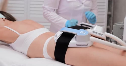 Professional Electrostimulation Session Close Up View o Therapist Applying EMS Device on Woman in