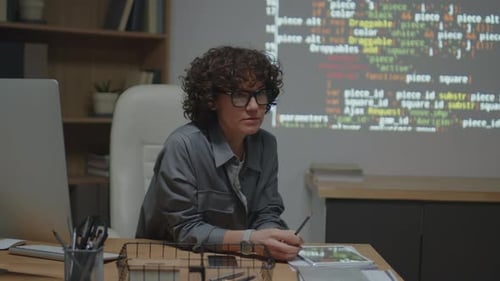 Woman Explains Computer Code on Display Screen