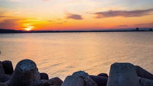 Breakwater Against the Background of a Cloudy Sky and the Black Sea with Waves
