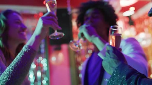 Adults Toasting with Champagne Flutes at Birthday Celebration