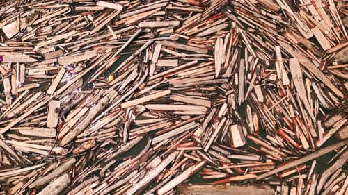 Aerial View of Log Jam Driftwood Accumulation Floating on Water Large Wood Debris Pile in River