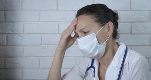 Worried Medical Professional Wearing Surgical Mask