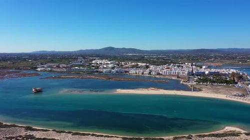 Aerial View of Fuseta Portugal Showing the Coastal Town with White Buildings a Sandy Beach Turquoise