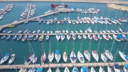 Topdown aerial footage of a marina with small yachts