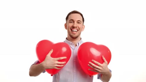 Happy Man Holding Red Heart-Shaped Balloons