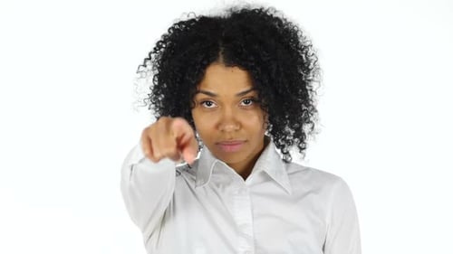 Woman Points Directly At Camera On White Background