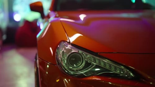Orange Sports Car Headlight Shining in Slow Motion