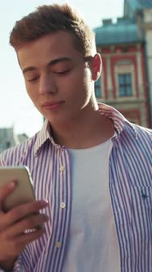 Smiling Young Happy Man Walk on Street Use Phone Look Around Sunlight Cute Work Mobile Gadget