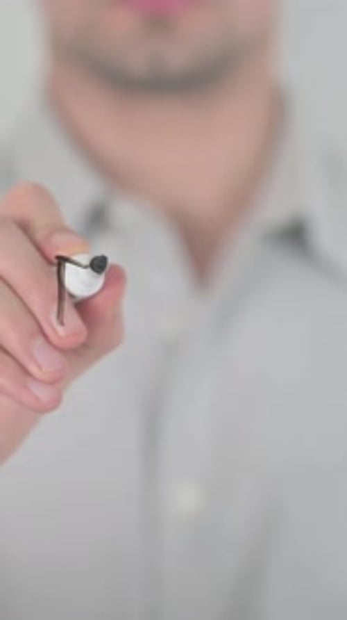 Man Writing 'Theme' on Glass with Marker