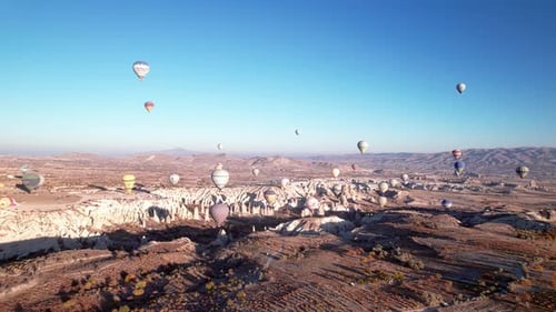 Hot Air Balloons Over Rocky Landscape