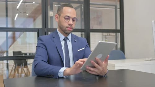 Man Celebrates Success During Video Call on Tablet