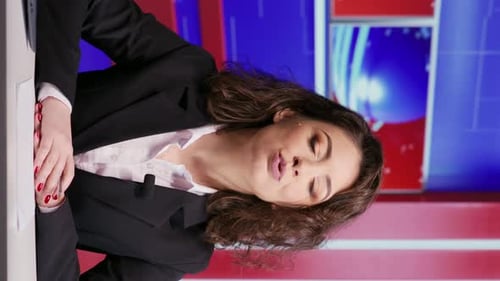 Woman News Anchor in Studio Broadcasts Current Events