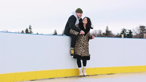 Affectionate Couple at Outdoor Winter Ice Rink