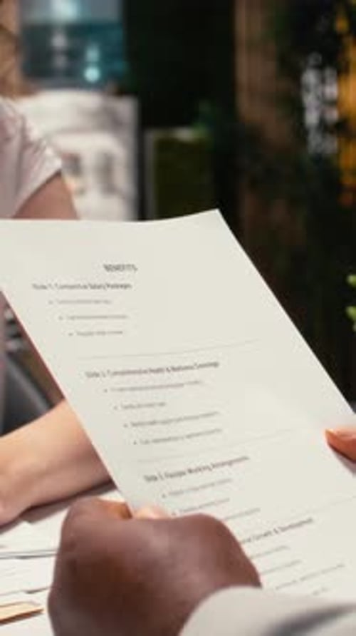 Vertical Video Close Up of Candidate Going Over Benefits Package and Salary Options