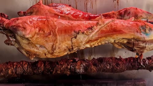 Roasting lamb on a BBQ spit