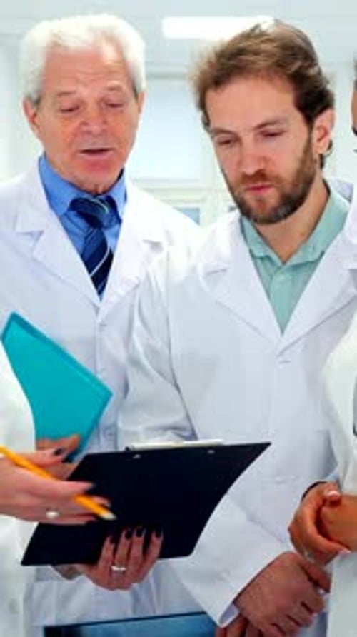 Medical Team Discussing Patient Notes in Hospital