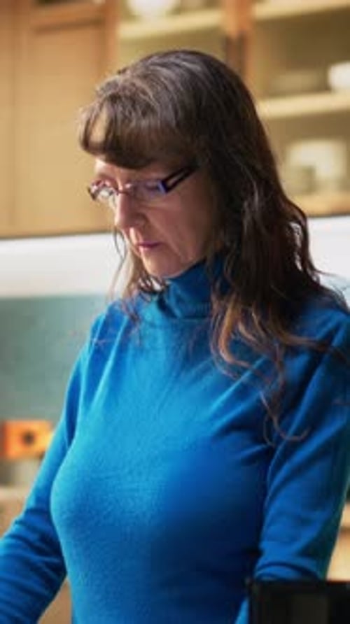 Woman Smiling Wearing Blue Turtleneck in Indoor Setting