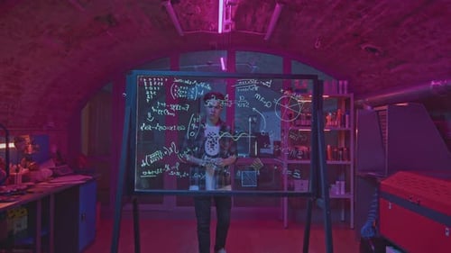 Young Man Solves Equations in Laboratory Media Student Solves Mathematical Equations in Secret