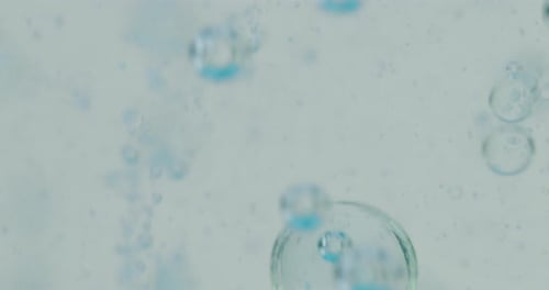 Slow motion macro of micro particles molecules in a liquid are analyzed with microscope for resear