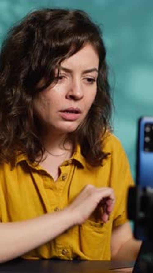 Vertical Video Woman Chatting with Subscribers Presenting Information on Notebook Device