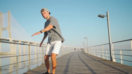 Man Ride Skateboard on Bridge