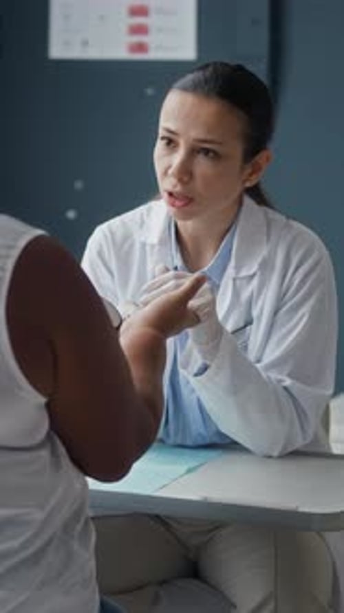 Dermatoscope Skin Examination of Black Female Patient Hand In Clinic