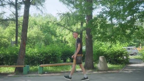 Teen Walking in Park on Sunny Day