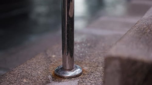 CloseUp of Metal Handrail on a Stone Staircase