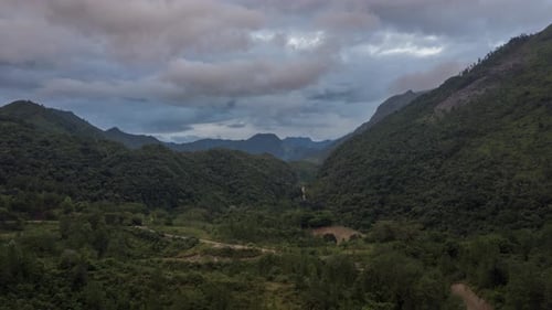 Drone aerial hyperlapse during sunset of a beautiful landscape view with mountains, cloud weather an