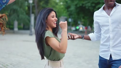 Group of Friends Smiling While Dancing on the Street