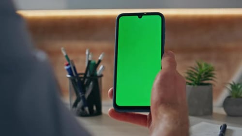 Hand Holds Phone with Green Screen